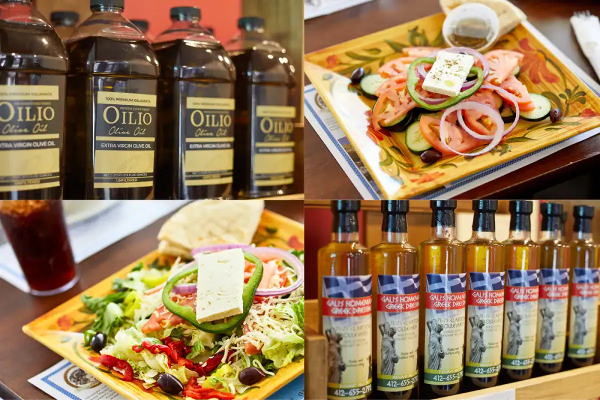 Bottles of olive oil and Greek dressing alongside fresh Greek salads.