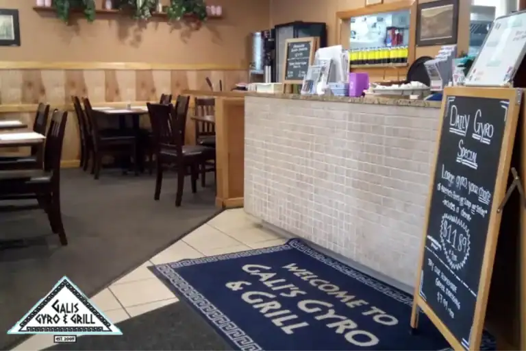 Greek restaurant counter area with daily gyro special sign.