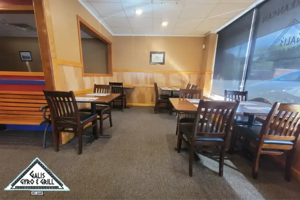 Greek restaurant dining area with tables and chairs.