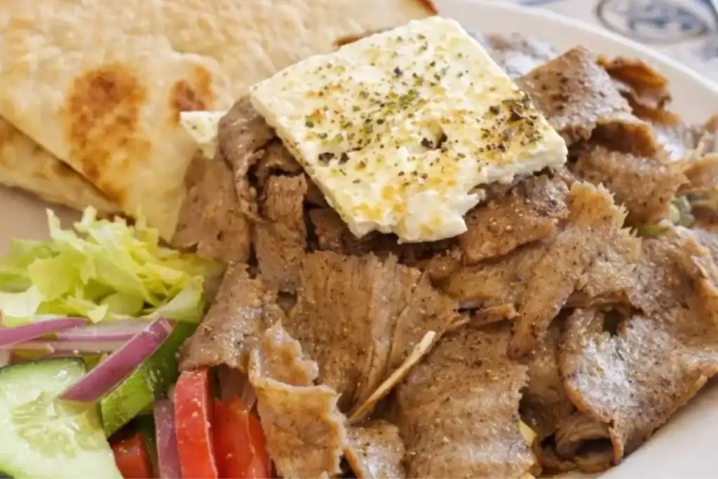 Authentic Mediterranean dish with seasoned gyro meat and fresh toppings
